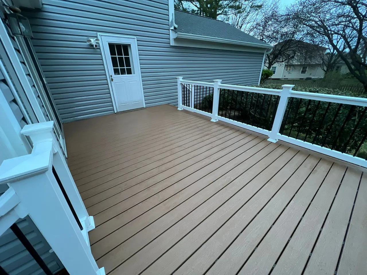 Tan composite deck install — Eagle Remodeling Services